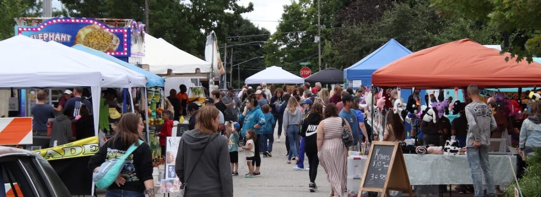 Crowd mingling between an assortment of food and product vendors at Stanton Old Fashioned Days Festival